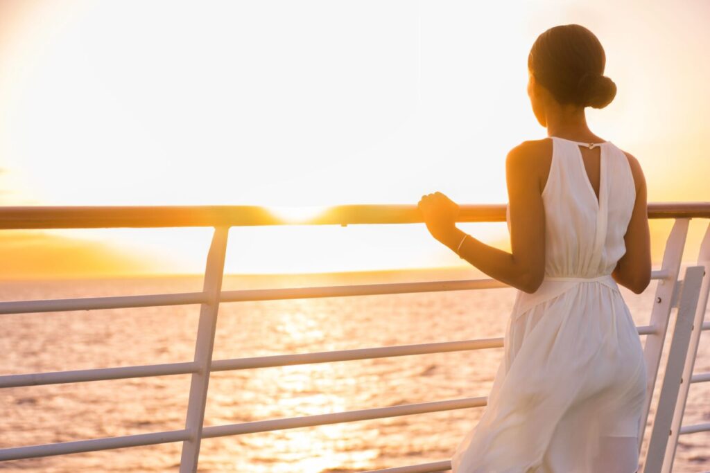 woman on a cruise ship at sunset