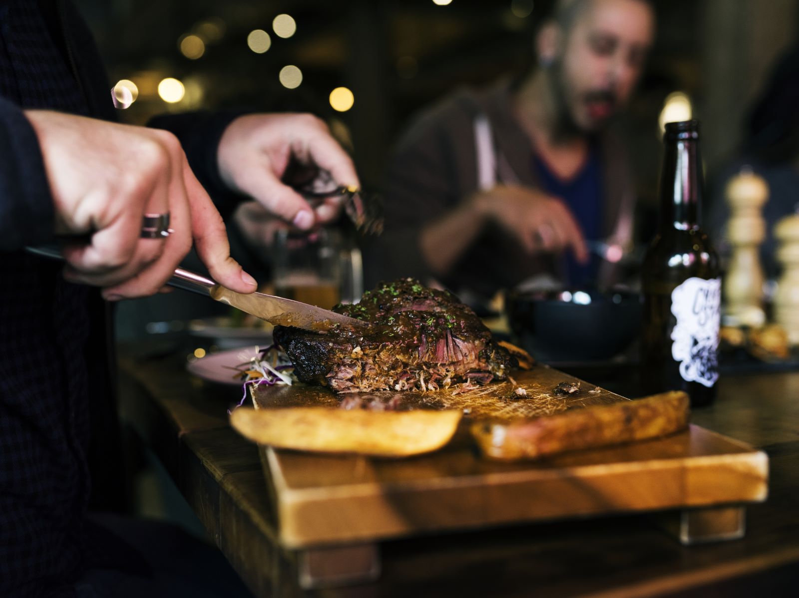 person cutting steak at restaurant in destin, fl